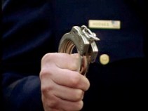 Handcuffs Held High in Final Salute for Sgt. Simpson
