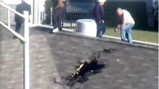 Runaway Tire Crashes Through Roof