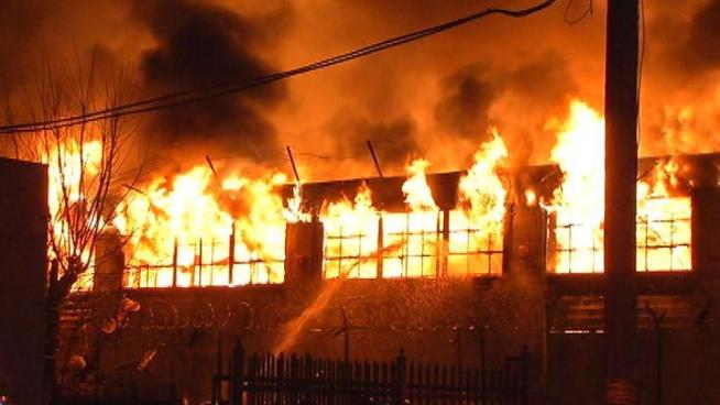 Hours after flames broke out in an abandoned Kensington warehouse, firefighters had the blaze under control but not yet extinguished.