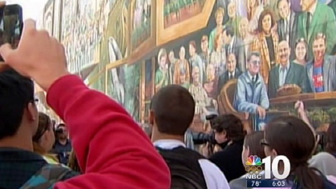 Artist Michael Pilato removed a halo from a mural of Penn State football coach Joe Paterno amid the school's child sex-abuse scandal. The artist added a large blue ribbon, instead, on Paterno's lapel symbolizing support for child abuse victims, a cause the artist said Paterno had endorsed.