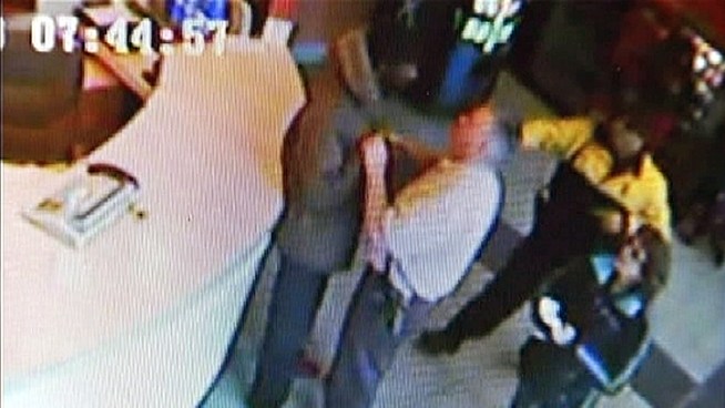 Surveillance video captures a man falling through a window after he tried to escape from a police officer. The man is accused of an armed robbery  inside a Resorts Casino bathroom.