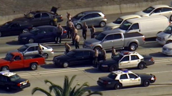 Raw Video: officers searched vehicle-to-vehicle on the northbound 110 Freeway on Friday after a bank robbery in Moreno Valley. 