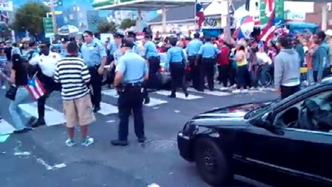 Cell phone video that appears to show a woman being struck by a police officer at the Philadelphia Puerto Rican Day Parade is getting hundreds of views on YouTube and is generating a lot of comments online.