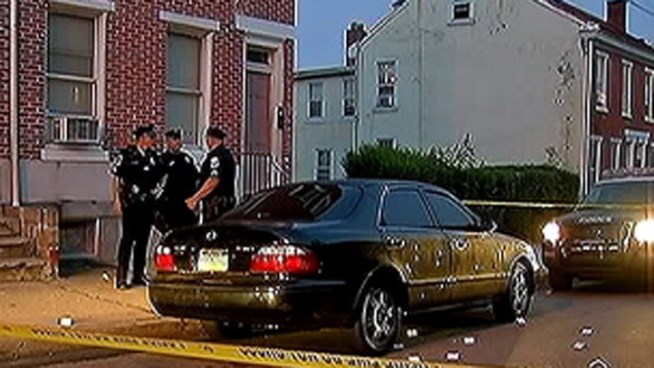 Police say dozens of bullets were fired on the 300 block of Moore St. early Tuesday morning. When police arrived to the scene they found a woman in the trunk of a car and three wounded men. Police tell NBC10's Terry Ruggles that one man is in custody.