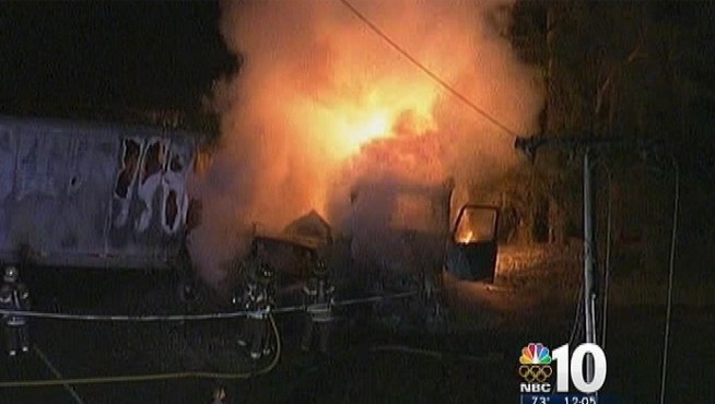 Rescuers scrambled to reach people trapped underneath a burning tractor trailer in Gloucester County. At least one person is dead.