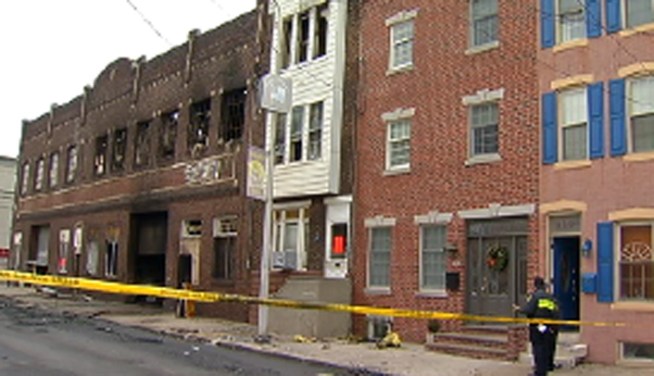 Investigators say electrical wiring caused the fire that damaged the warehouse where decorated Mummers group the Fralinger String Band stored their items. Officials say  the problem started at or near an unlicensed auto repair business. NBC10's Harry Hairston reports.