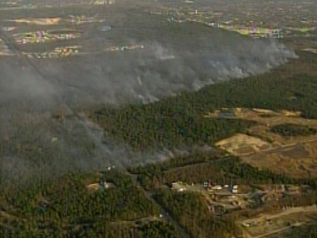 Dozens of residents are displaced to shelters after fire threatens homes.