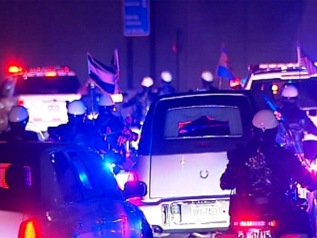 A procession of blue led the body of <a title=