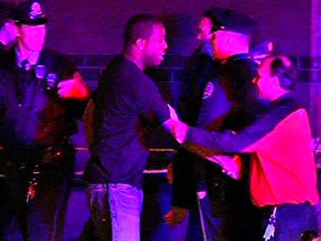 A 7-11 worker hugs the off-duty officer who walked in during a holdup at his store early Friday morning, March 19, 2010. The officer chased the gunman behind a dormitory at St. Joe's University. Gunshots were fired.