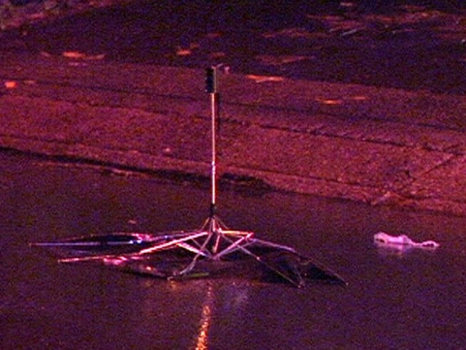 The victim's umbrella, shoes and other belongings were left in the street where she was struck Monday night. <a title=