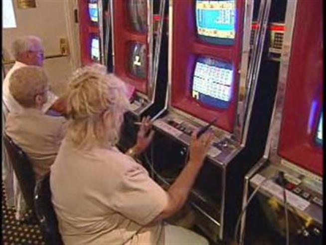 Atlantic City casino patrons smoking while gambling.