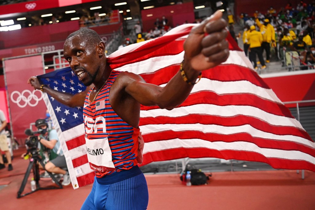 Team USA's Paul Chelimo celebrates with the national flag after winning the bronze medal in the men's 5000m final during the Tokyo 2020 Olympic Games at the Olympic Stadium in Tokyo on Aug. 6, 2021.