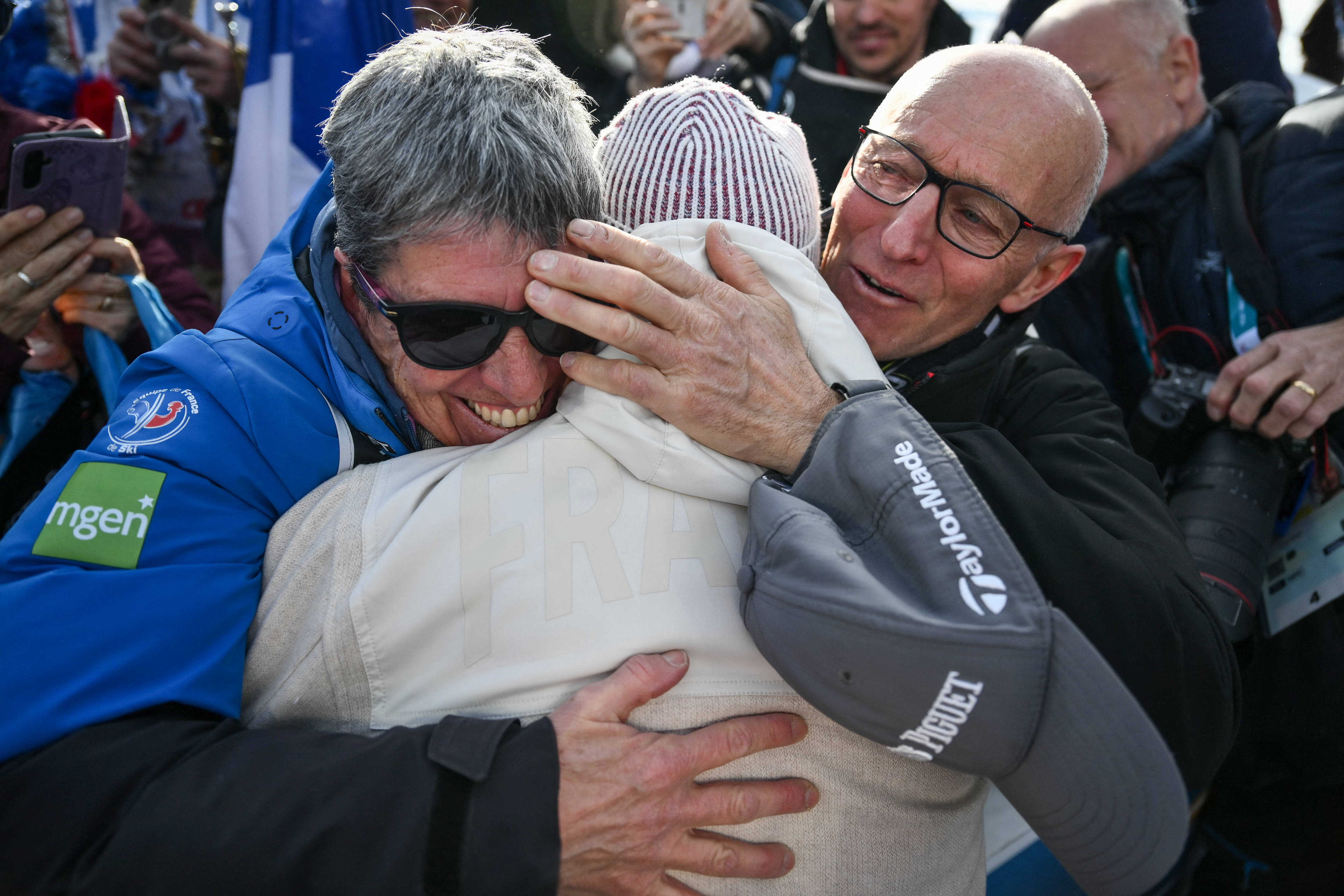 Quentin Fillon Maillet is congratulated by his parents