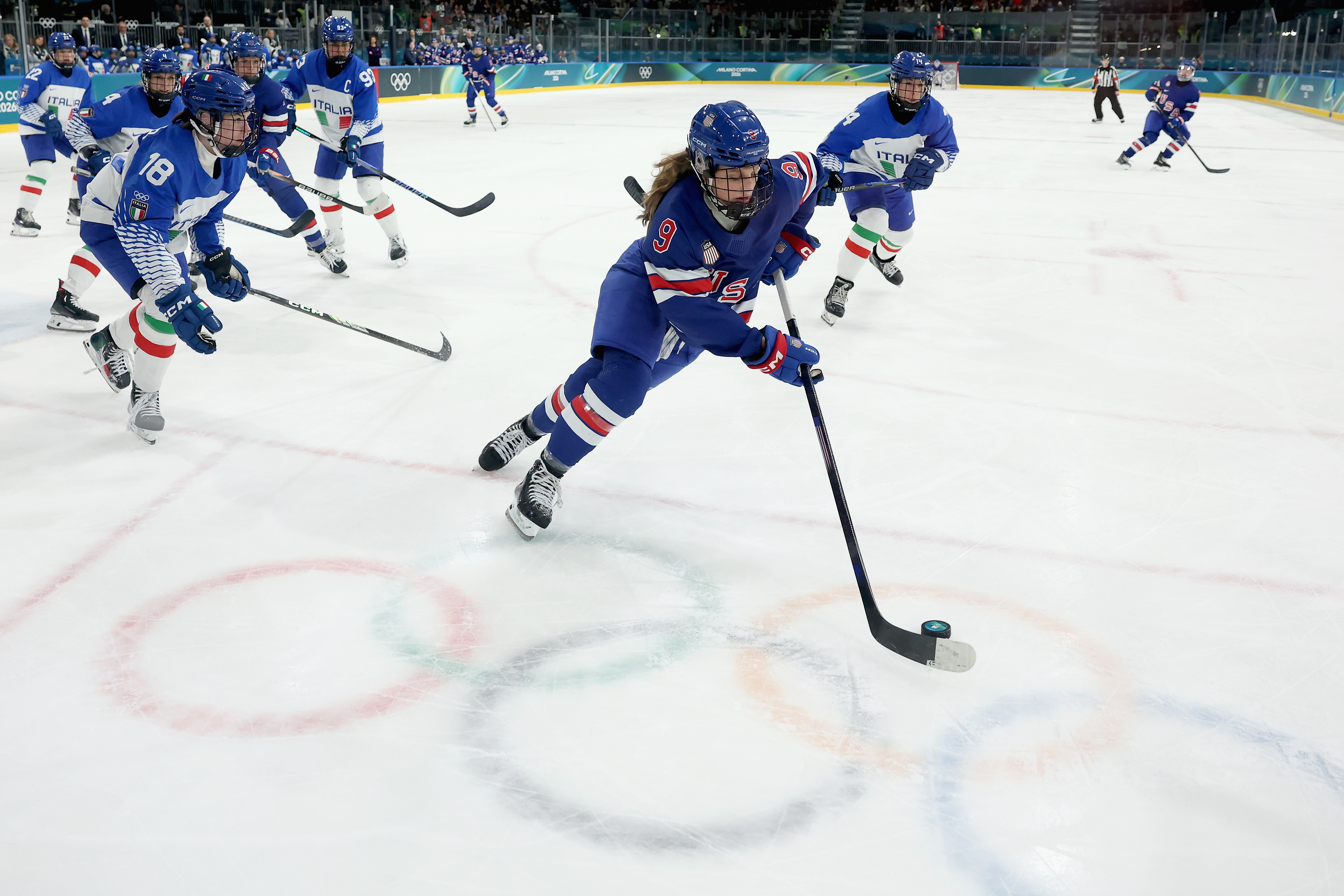 Kirsten Simms of Team United States skates with the puck in the third period during the Women's Quarterfinals match between the United States and Italy.