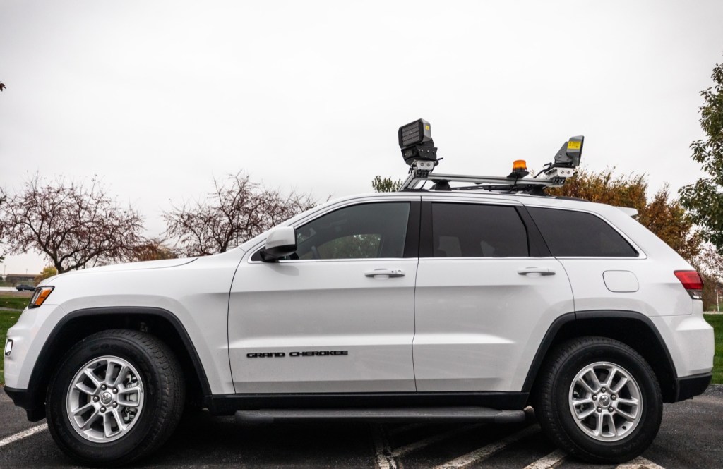 A speed camera system mounted to a white SUV