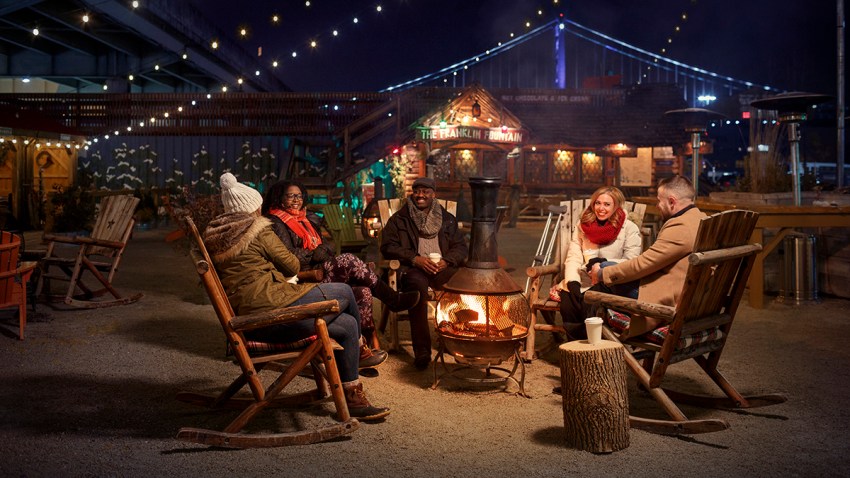 People around a fire at Winterfest