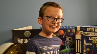 Young boy with space books