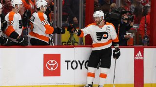 Hockey player fist-bumps teammates