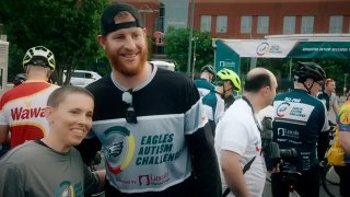 Carson Wentz wearing an Eagles Autism Challenge shirt