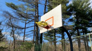Caution tape on a basketball hoop