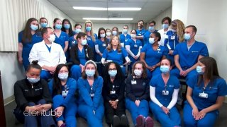 A group of nurses in scrubs and masks