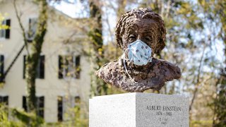 Statue of Albert Einstein in a mask