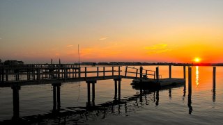 A pier at the beach in the sunset