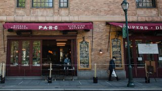 A man walks by a restaurant