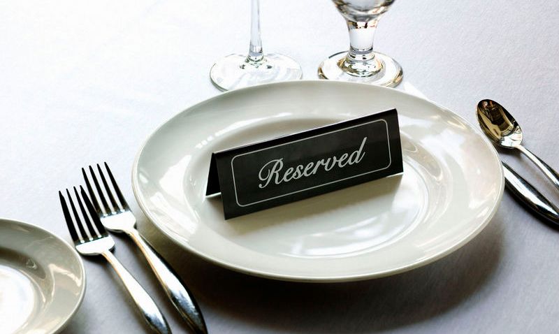 Reserved placard on place setting at fine dining restaurant.