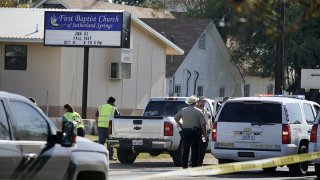 Law enforcement officers gather in front of the First Baptist Church of Sutherland Springs after a fatal shooting killed more than two dozen people on Sunday, Nov. 5, 2017, in Sutherland Springs, Texas.