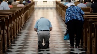 Parishioner attend mass celebrated by Bishop Ronald Gainer, of the Harrisburg Diocese, at the Cathedral Church of Saint Patrick in Harrisburg, Pennsylvania, Friday, Aug. 17, 2018.