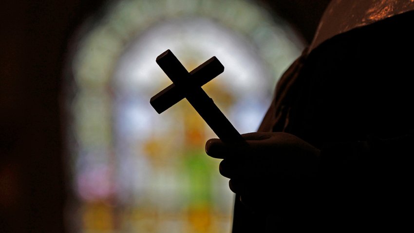 File photo of a crucifix and a stained glass window inside a Catholic Church.