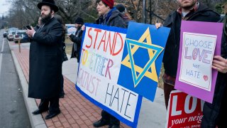 In this Dec. 29, 2019, file photo, neighbors gather to show their support of the community near a rabbi's residence in Monsey, New York.