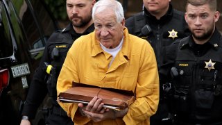 Former Penn State University assistant football coach Jerry Sandusky, center, arrives at the Centre County Courthouse to be resentenced in Bellefonte, Pennsylvania, on Nov. 22, 2019.