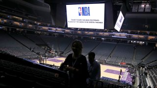 Fans leave the Golden 1 Center after the NBA basketball game between the New Orleans Pelicans and Sacramento Kings was postponed at the last minute in Sacramento, Calif., Wednesday, March 11, 2020.