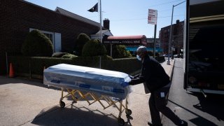 A man delivers caskets to the Gerard Neufeld Funeral Home