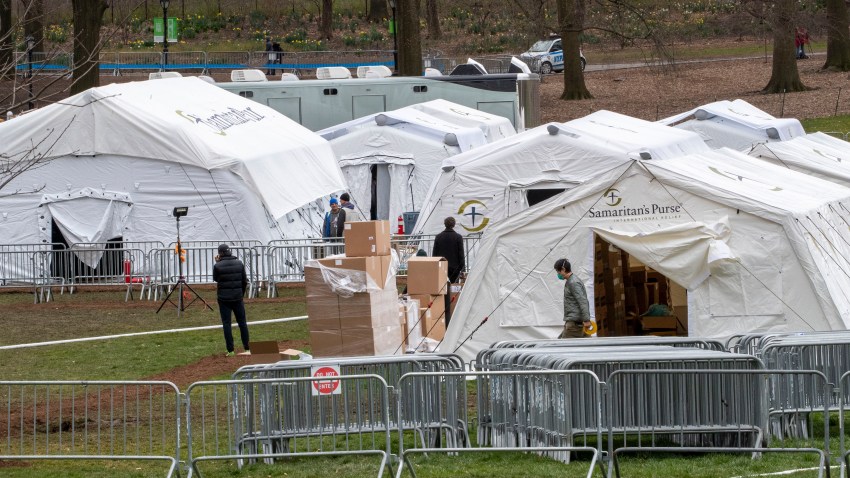 In this March 31, 2020, file photo, Samaritan's Purse crew and medical personnel work on preparing to open a 68 bed emergency field hospital specially equipped with a respiratory unit in New York's Central Park in New York.