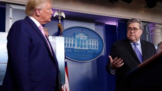 President Donald Trump listens as Attorney General William Barr speaks about the coronavirus in the James Brady Press Briefing Room of the White House, Wednesday, April 1, 2020, in Washington.