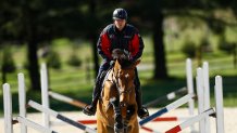 Phillip Dutton, a medal-winning equestrian on the U.S. Olympic team, rides Z, through a series of jumps while training at his farm, Thursday, April 2, 2020, in West Grove, Pa.