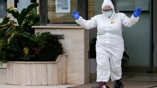 A medical staffer gestures after performing swabs for coronavirus in the Santa Cecilia nursing home in Civitavecchia, near Rome