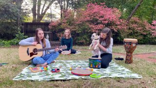 In this April 10, 2020 image from video, music therapists for St. Jude Children’s Research Hospital, from left, Celeste Douglas, intern Abigail Parrish and Amy Love record a session in Love’s backyard in Memphis, Tennessee.