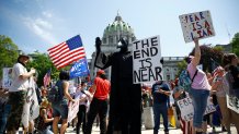 Protesters demonstrate during a rally against Pennsylvania's coronavirus stay-at-home order at the state Capitol in Harrisburg, Pa., Friday, May 15, 2020.