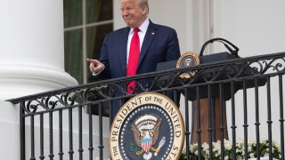 President Donald Trump points during a "Rolling to Remember Ceremony," to honor the nation's veterans and POW/MIA, from the Blue Room Balcony of the White House, Friday, May 22, 2020, in Washington.