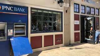 A cleanup crew began removing shards of glass and furniture at a PNC bank in Trenton, NJ, Monday, June 1, 2020.
