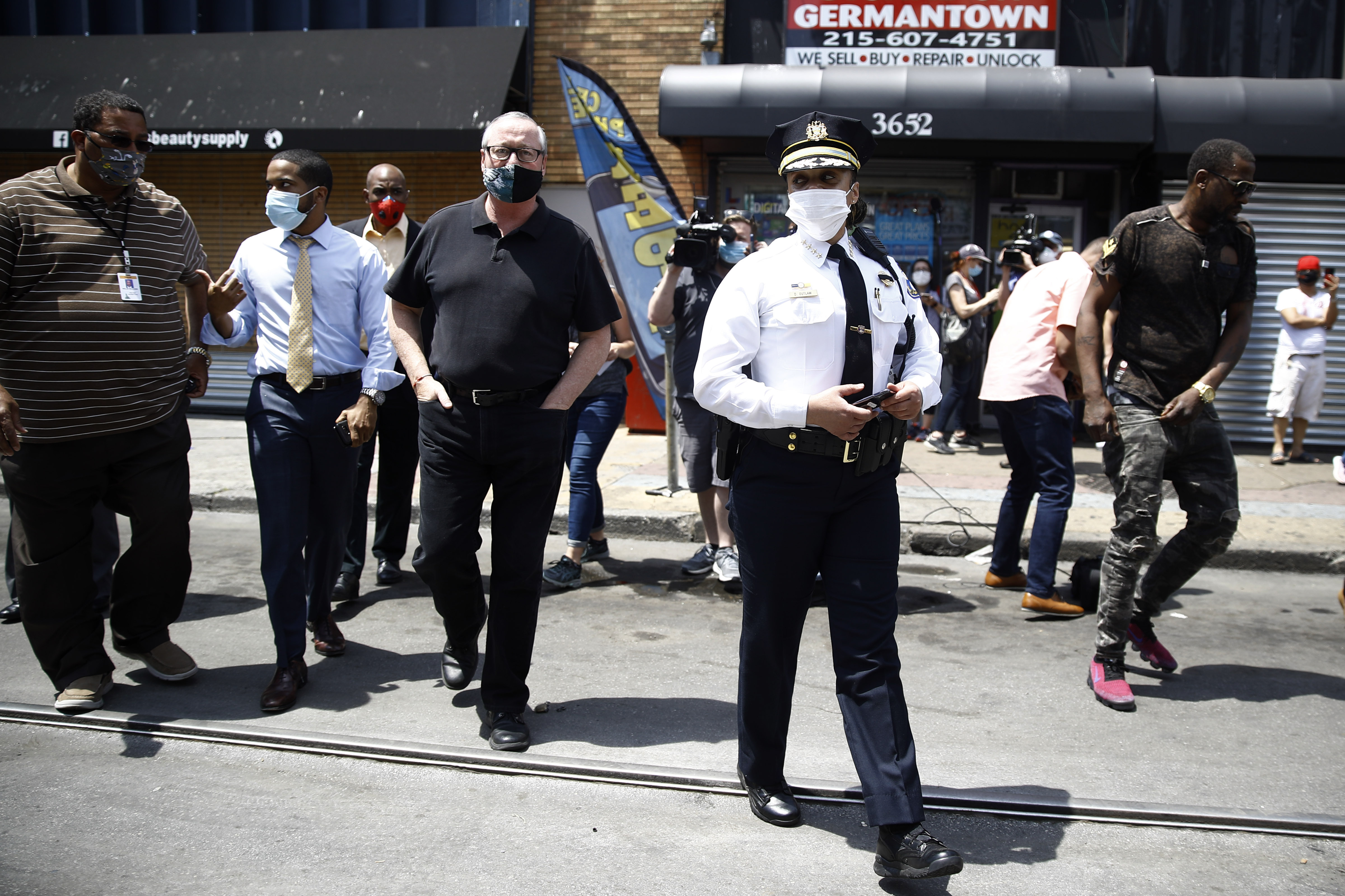 Philadelphia Police Commissioner Danielle Outlaw, center, and Mayor Jim Kenney, 4th left, meet with people, Thursday, June 4, 2020, in Philadelphia after days of protest over the May 25 death of George Floyd, who died after being restrained by police in Minneapolis.