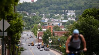 A cyclist pedals up a hill in Allentown, Pennsylvania, May 29, 2020. Allentown predicts a budget deficit of over $10 million, a number officials say could go higher if the economy doesn’t rebound quickly.