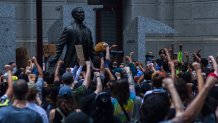 protesters demonstrate outside City Hall