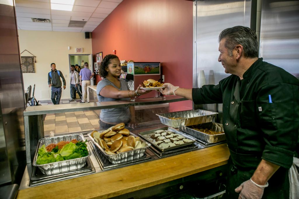 man feeding woman at food pantry