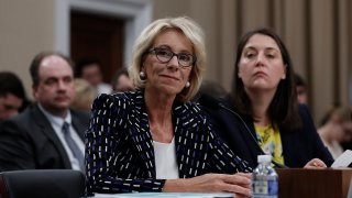In this May 24, 2017, file photo, Education Secretary Betsy DeVos, left, joined by Education Department Budget Service Director Erica Navarro, testifies before the House Appropriations Labor, Health and Human Services, Education, and Related Agencies subcommittee hearing on the Education Department's fiscal 2018 budget on Capitol Hill in Washington, DC.