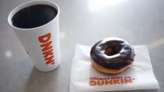 In this Jan. 30, 2020, file photo, a Dunkin' black coffee and chocolate frosted donut are photographed at a location in Mount Washington, Kentucky.